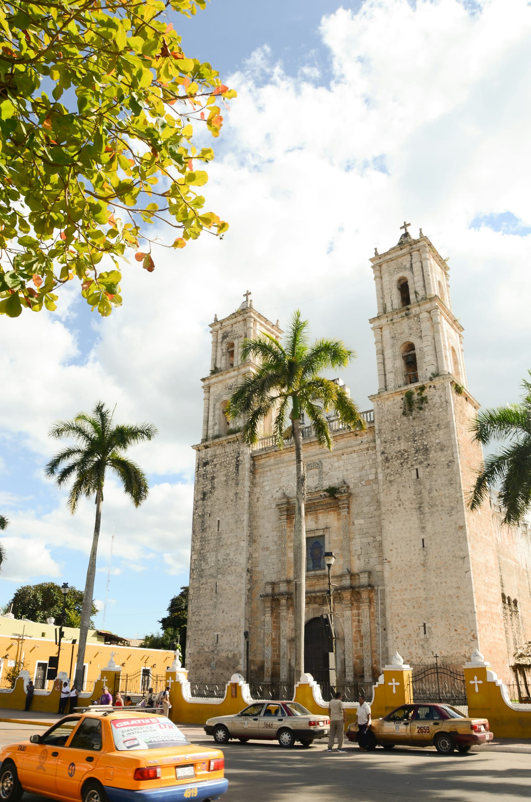 The church on the main square in Valladolid, taxis waiting along the wall
